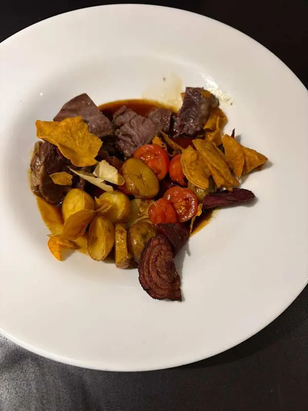 Dados De Meloso De Ternera Con Mini Patatas, Cherry, Jugo De Asado y Chips De Verduras